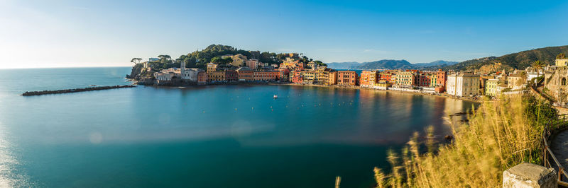 Aerial view of town by sea against sky