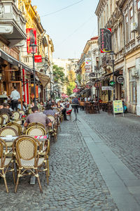 Sidewalk cafe amidst buildings in city