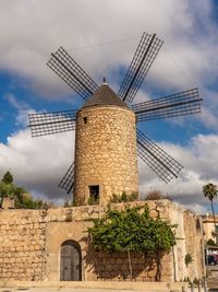 Traditional windmill against sky