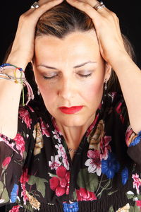 Close-up of beautiful young woman with eyes closed at night