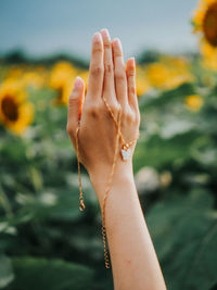 Cropped hand of woman with jewelry outdoors