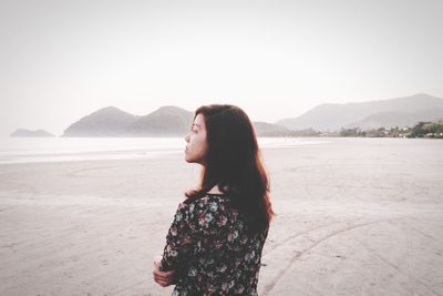 Portrait of woman standing on shore