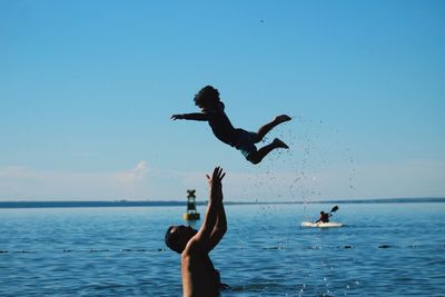 Low angle view of father and son on beach