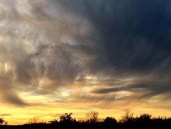 Low angle view of dramatic sky during sunset