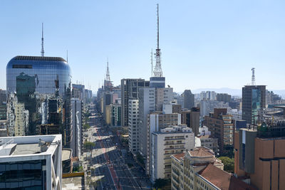 Modern buildings in city against clear sky