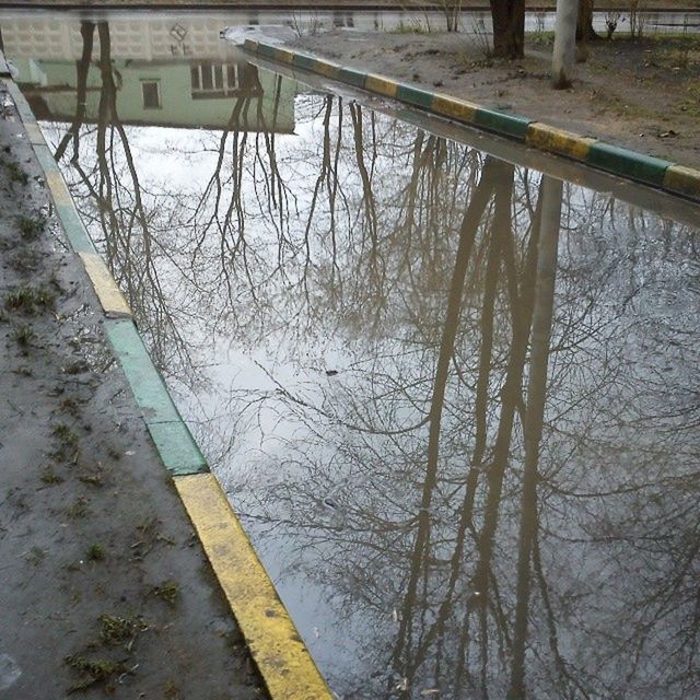 water, reflection, lake, river, high angle view, tree, tranquility, railing, nature, puddle, transportation, outdoors, day, canal, no people, connection, bare tree, tranquil scene, standing water, built structure