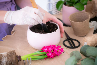 Cropped hand of person preparing food on table