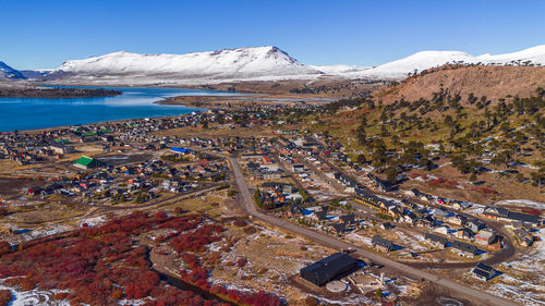 High angle view of townscape by sea against sky