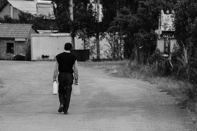 Full length of man walking on road