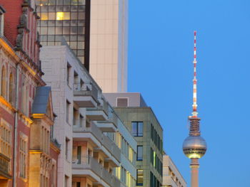 Berlin tv tower and internationales handelszentrum ihz wit surrounded buildings at dawn