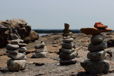 Stack of stones on beach against clear sky