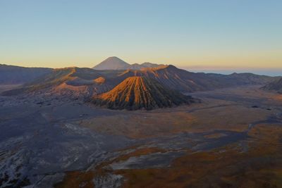 Scenic view of volcano against clear sky during sunset