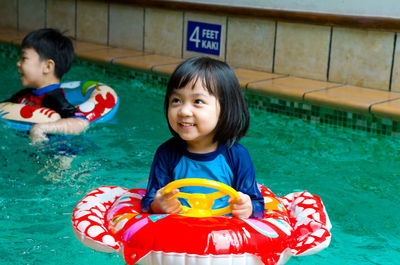 Cute smiling girl in swimming pool