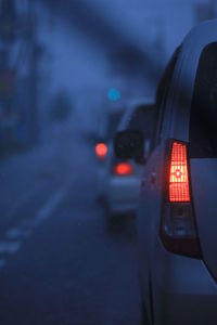 Close-up of wet car on road