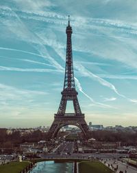 Eiffel tower in city against sky