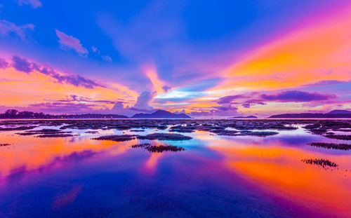 Scenic view of sea against romantic sky at sunset