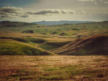 Scenic view of landscape against cloudy sky