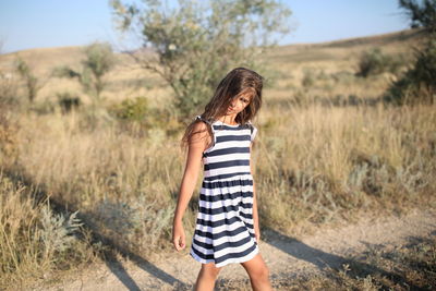 Full length of woman standing on field