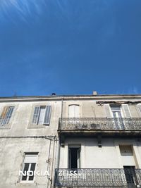 Low angle view of building against clear blue sky