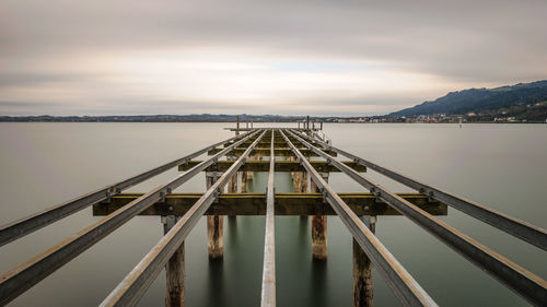 Bridge over lake against sky