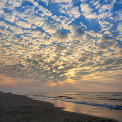 Scenic view of beach against sky during sunset