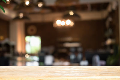 Close-up of lit candles on table in restaurant