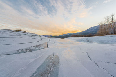 Scenic view of landscape against sky during winter