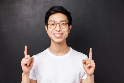 Portrait of smiling mid adult man against black background