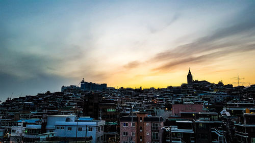 Buildings in city at sunset