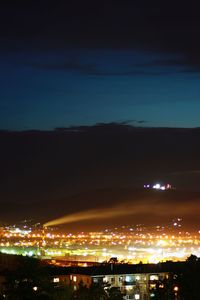 High angle view of illuminated buildings against sky at night