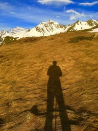 Shadow of man on mountain against sky