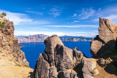 Panoramic view of rocks and sea against sky