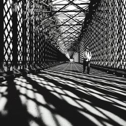 Man walking on bridge