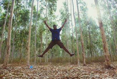 Man jumping in forest