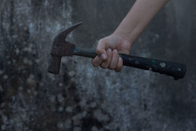 Cropped hand holding hammer