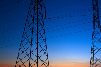 Low angle view of electricity pylon against sky