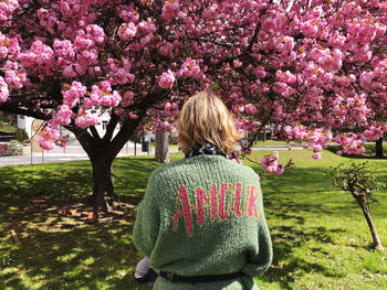 Rear view of woman standing amidst plants