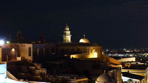 Illuminated buildings in city at night