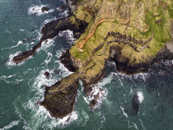 High angle view of rock formation and sea