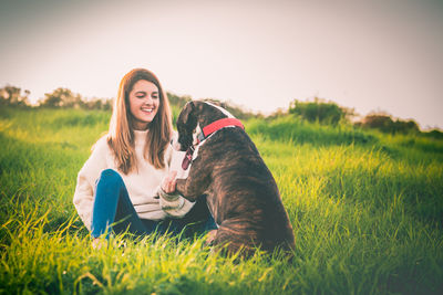 Woman with dog on field