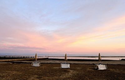 Scenic view of beach against sky during sunset