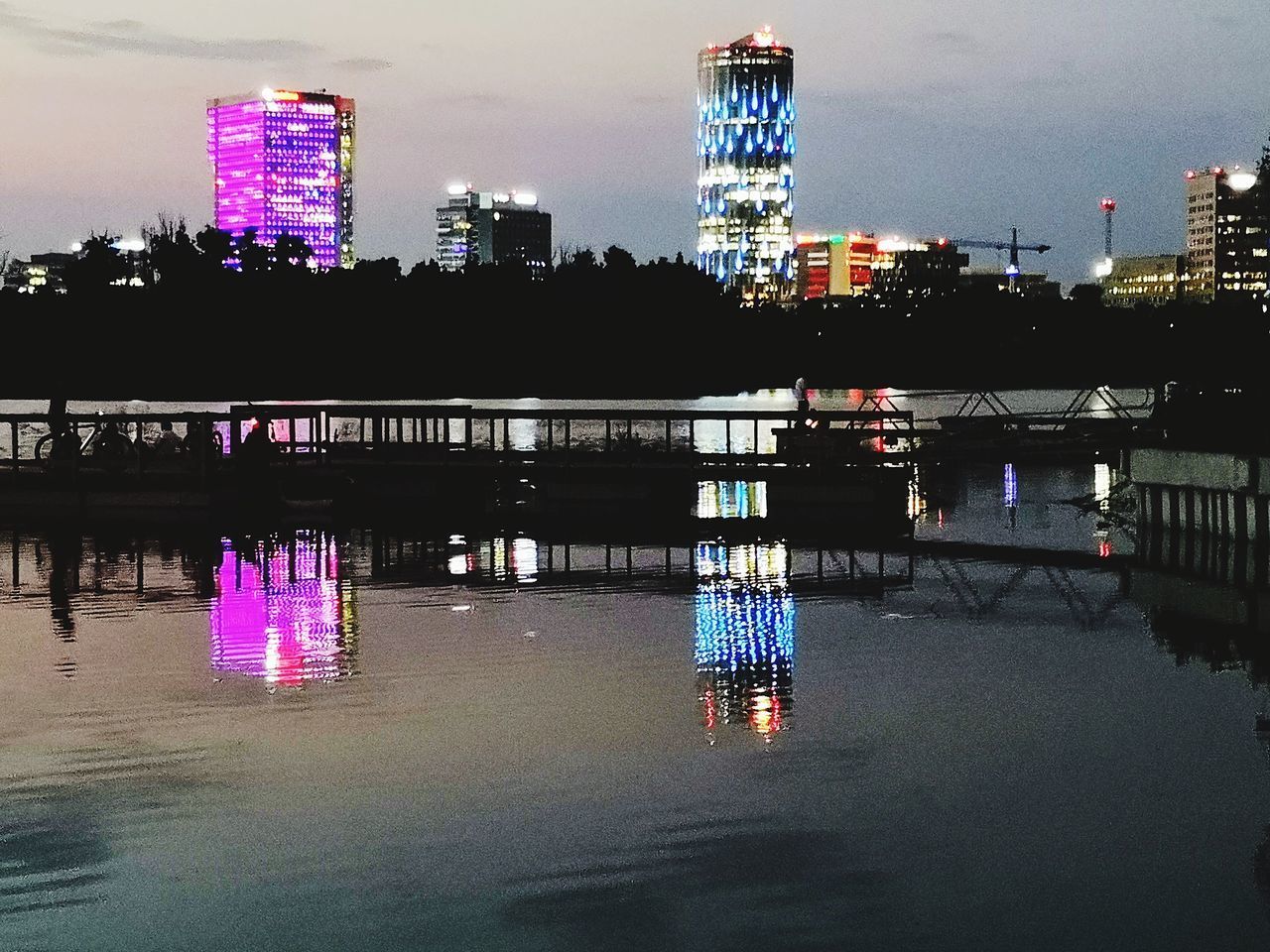 ILLUMINATED BUILDINGS IN CITY AT NIGHT