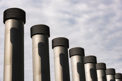 Low angle view of smoke stack against sky