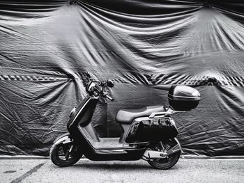 Motor scooter against fabric 