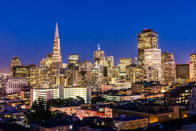 Illuminated buildings in city at night