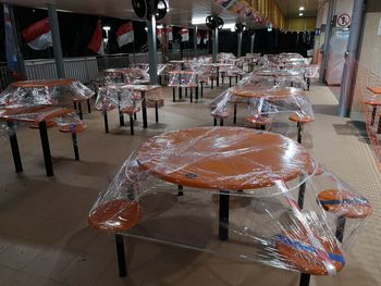 Empty chairs and tables in restaurant