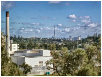 Buildings against cloudy sky