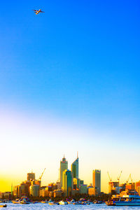 Buildings in city against blue sky
