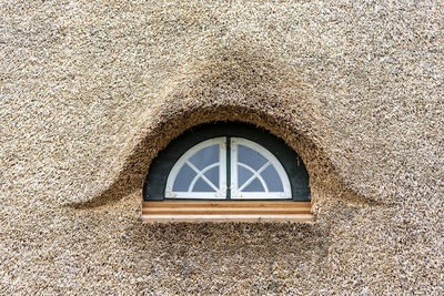 Low angle view of window on wall of building