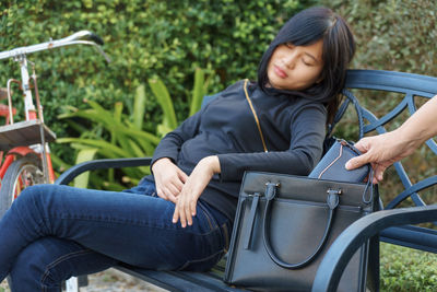 Full length of woman sitting on seat